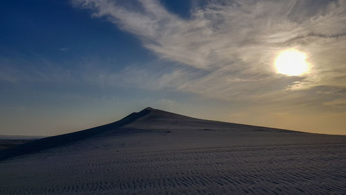 Scenic view of desert against sky during sunset