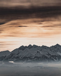 Scenic view of snowcapped mountains against sky during sunset