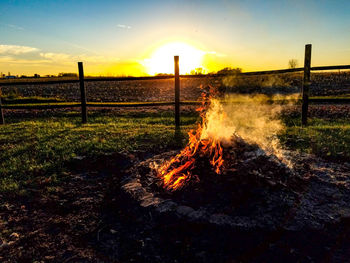 Bonfire against sky during sunset