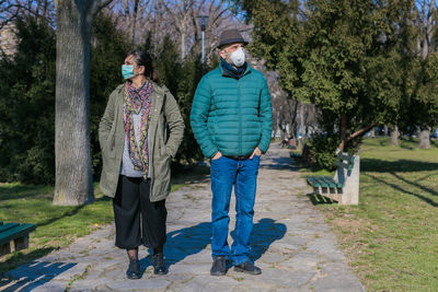 Man and woman standing on footpath