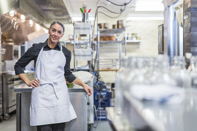 Portrait of confident chef standing at restaurant kitchen