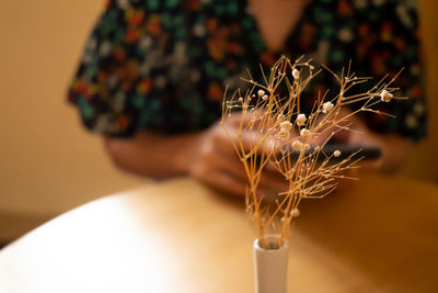 Midsection of woman sitting on table