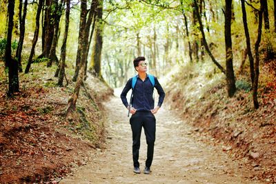 Full length of man standing on dirt road