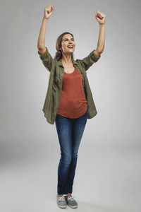 Portrait of smiling young woman against white background