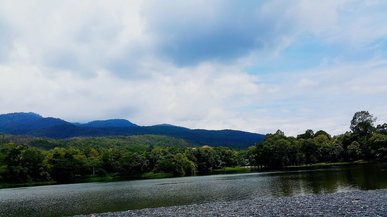 sky, mountain, tranquil scene, tranquility, scenics, cloud - sky, water, tree, beauty in nature, nature, cloudy, cloud, lake, mountain range, landscape, river, non-urban scene, idyllic, day, growth