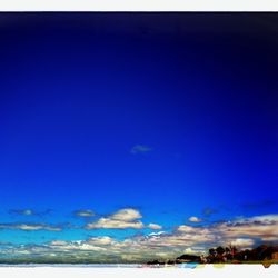 Scenic view of landscape against blue sky