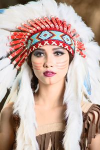 Portrait of young woman wearing north american tribal costume