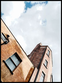 Low angle view of building against cloudy sky