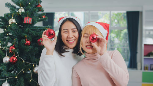 Portrait of young woman with christmas tree