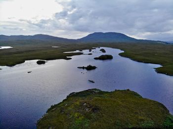 Scenic view of river amidst mountains against sky