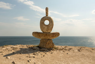 View of rocks on beach against sky