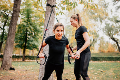 Low angle view of women exercising at park