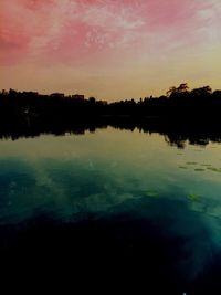 Scenic view of lake at sunset