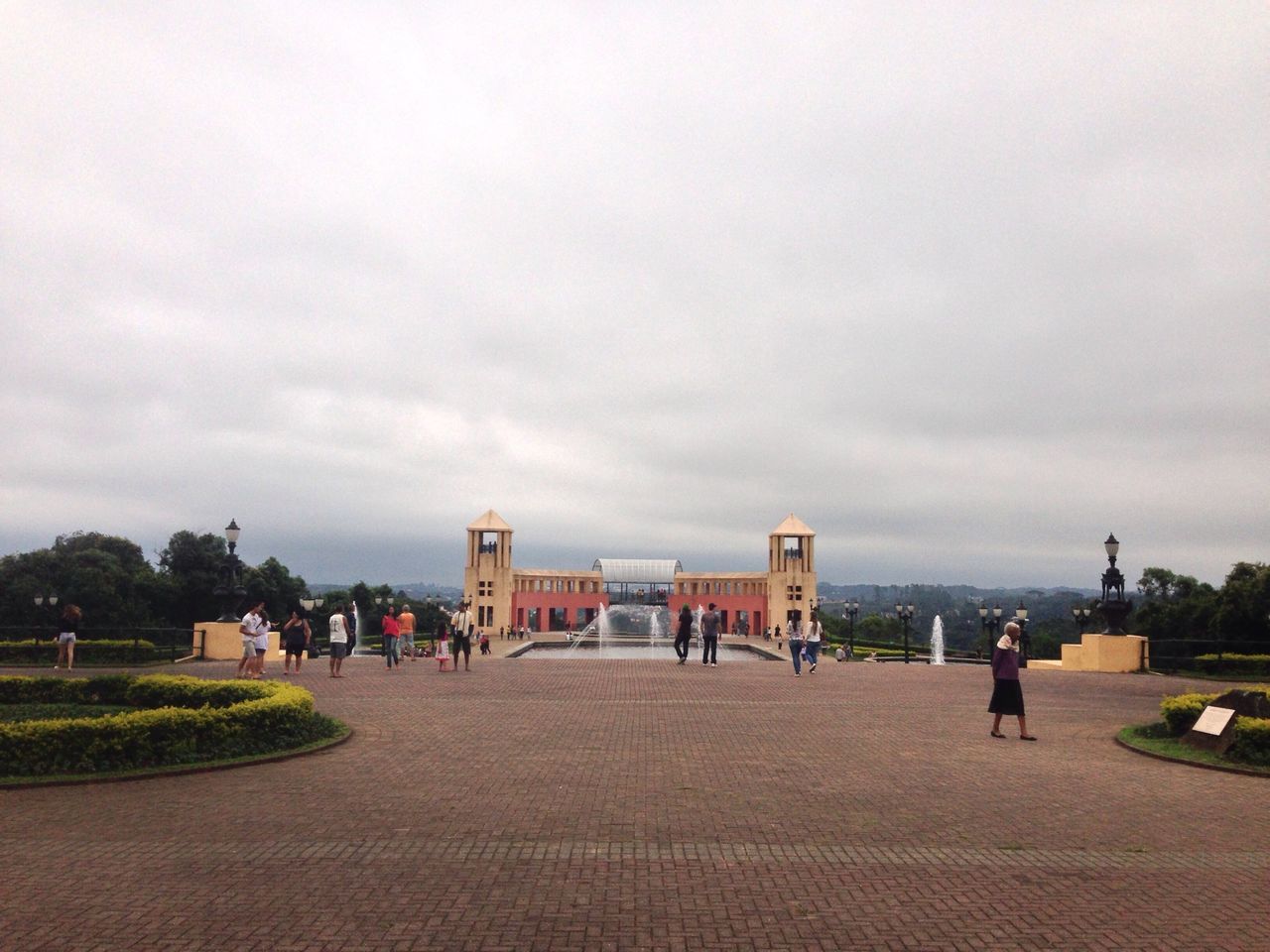 sky, built structure, architecture, building exterior, cloud - sky, the way forward, cloudy, footpath, road, cloud, men, mid distance, incidental people, street, walking, person, tree, day, outdoors