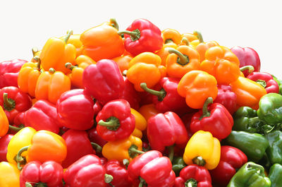 Close-up of colorful bell peppers against white background