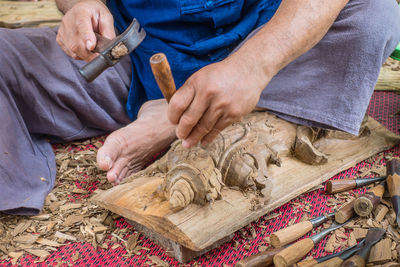 Close-up of man working on wood