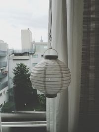 Close-up of clothes hanging against the sky