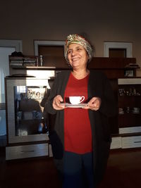 Portrait of a smiling young man drinking glass
