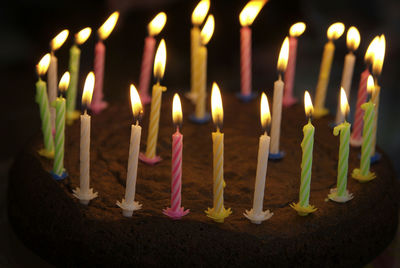 Homemade chocolate birthday cake with lit candles