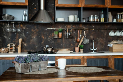 View of coffee and vegetables on table at home