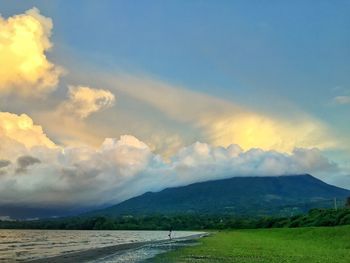 Scenic view of mountains against cloudy sky