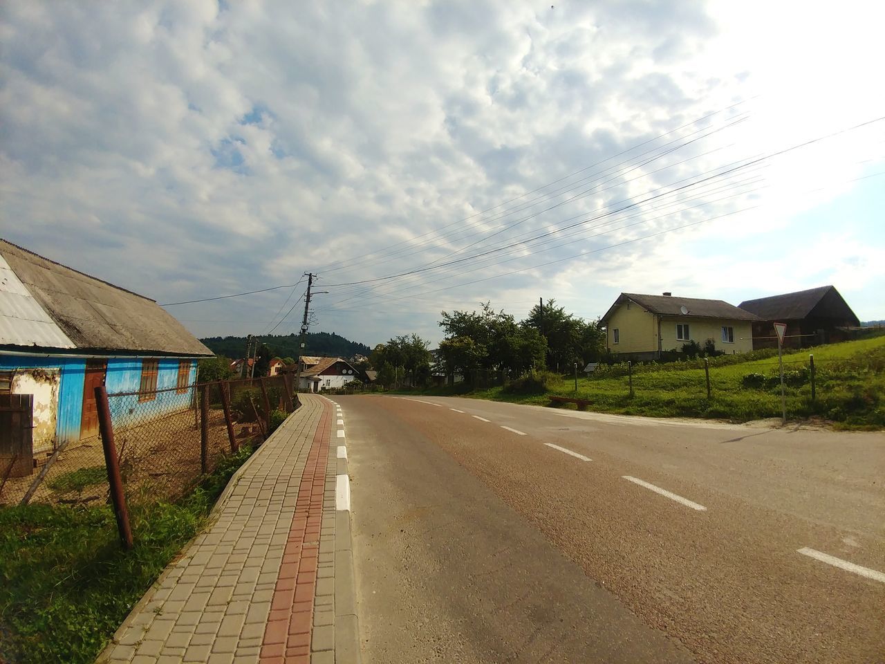 building exterior, built structure, architecture, sky, cloud - sky, road, house, building, residential district, nature, direction, the way forward, transportation, day, plant, street, outdoors, no people, city, tree