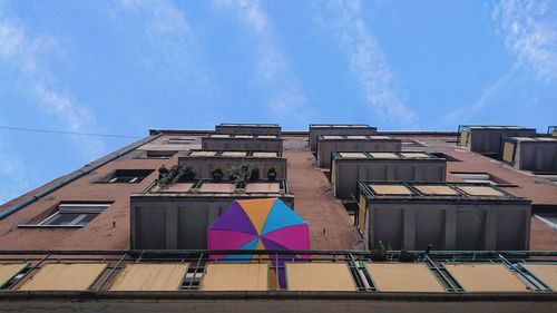 Low angle view of residential building against blue sky