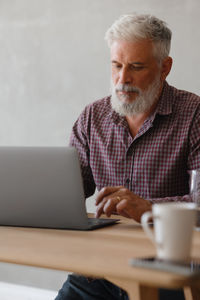 Young man using laptop at table