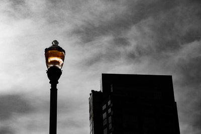 Low angle view of illuminated street light against sky