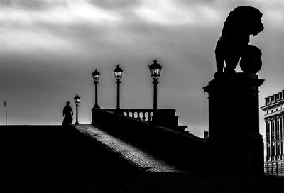Silhouette of statue against cloudy sky