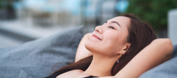 Smiling woman relaxing on sofa