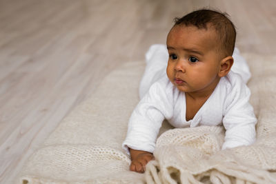 Portrait of cute baby on bed