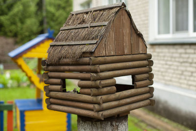 Close-up of birdhouse against building
