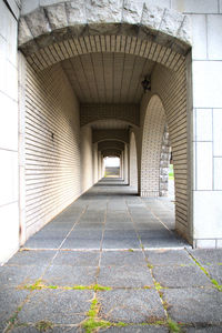 Empty corridor along walls and building