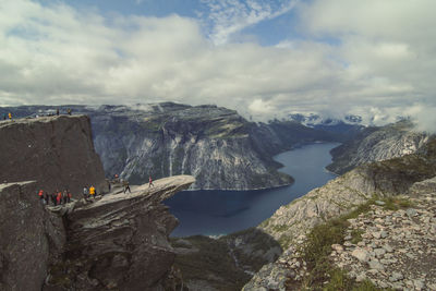 Steep troll tongue cliff over river landscape photo