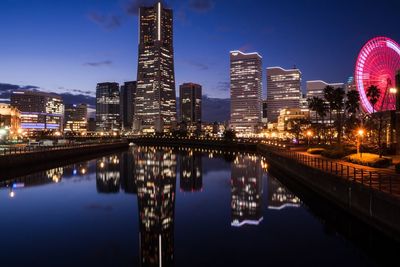 Reflection of illuminated buildings in city at night