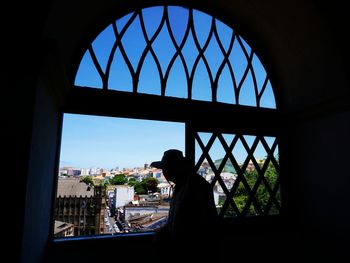 Silhouette of buildings seen through window