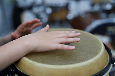 Close-up of hands playing drum 