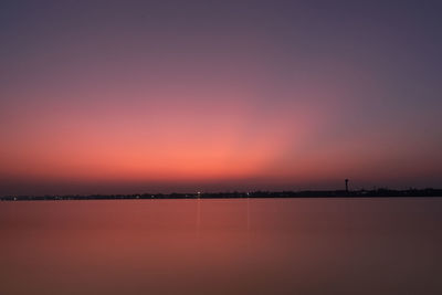Scenic view of lake against romantic sky at sunset