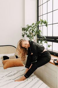 Portrait of young woman sitting on sofa at home