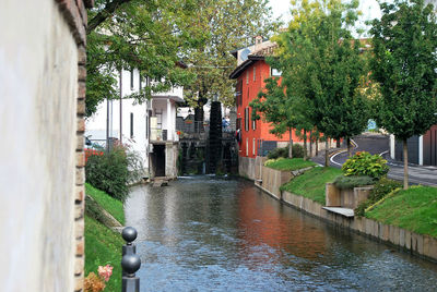 Canal amidst trees and buildings