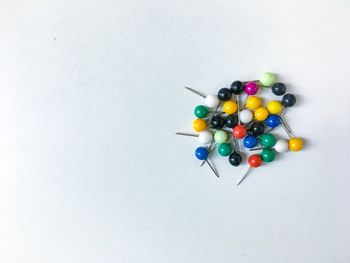 High angle view of colorful candies against white background