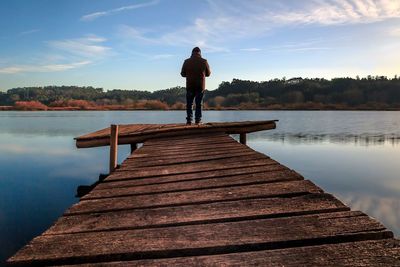 Rear view of man standing on pier