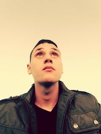 Portrait of young man against white background