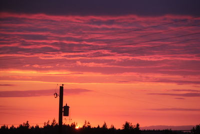 Silhouette street light against sky during sunset