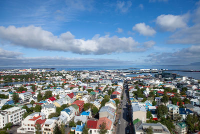 High angle view of townscape by sea against sky