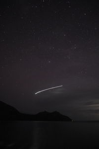 Scenic view of lake against sky at night