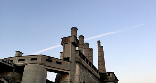 Low angle view of factory against sky