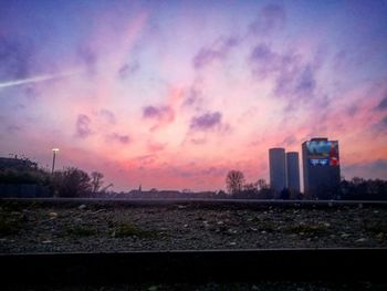 Scenic view of city against sky at sunset