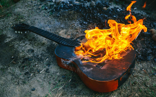 Shot of an acoustic guitar engulfed in strong flames